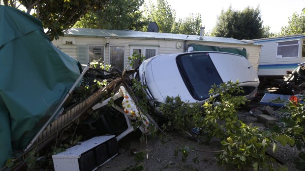 Debris and a damaged car are pictured in the campsite of Biot, near Cannes.
