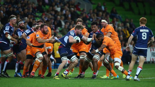 Adam Thompson of the Rebels is tackled during the round nine against the Cheetahs.