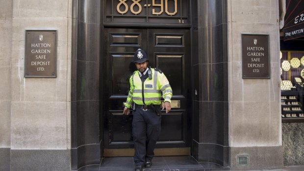A British police officer leaves a safe deposit building on Hatton Garden.