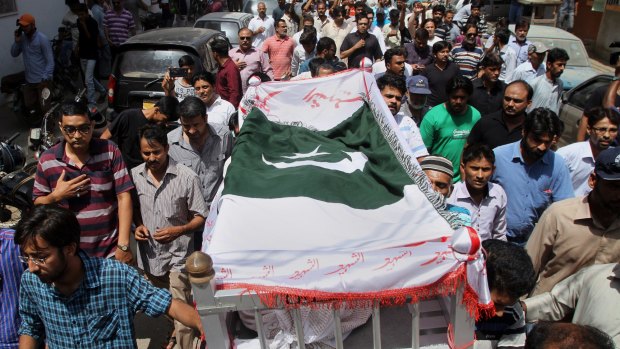 Mourners carry the coffin of slain activist Khurram Zaki in Karachi.