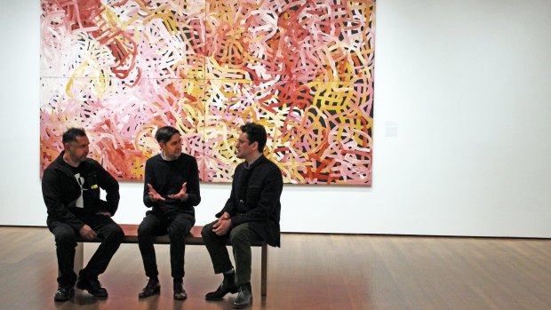 Vernon Ah Kee, Stephen Gilchrist, and Narayan Khandekar at the Harvard Art Museum exhibition in front of Emily Kame Kngwarreye's 1996 painting Big Yams.