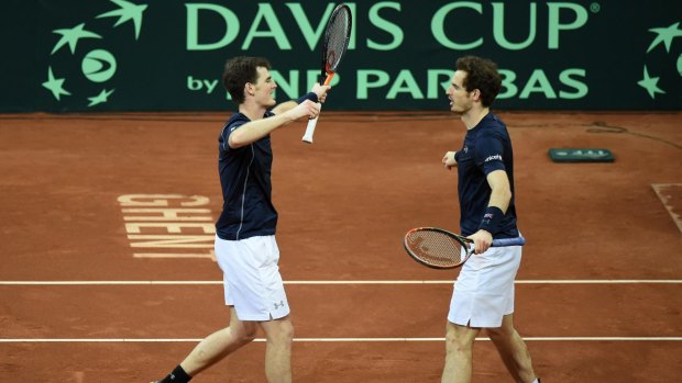 Relief: Britain's Andy Murray, right, celebrates with his brother Jamie Murray, left, after defeating Belgium's Steve Darcis and David Goffin in their Davis Cup final doubles clash.