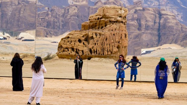 Tourists get photos outside Maraya in Saudi Arabia.
