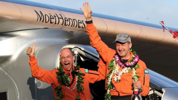 A record-breaking five-day flight ... Bertrand Piccard (left) celebrates with Andre Borschberg after the Solar Impulse 2 airplane touched down in Hawaii.