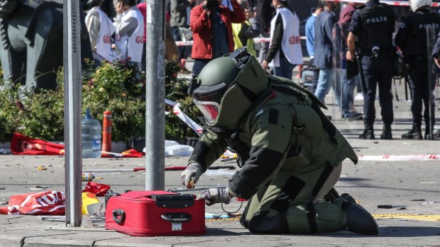 A Turkish bomb disposal expert investigates a suitcase at the scene of a blast during a peace rally in Ankara in October.