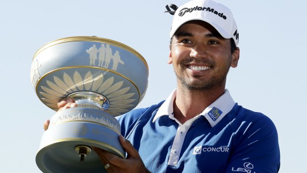 Jason Day holds the trophy after winning the championship golf tournament at Austin Country Club in Texas.