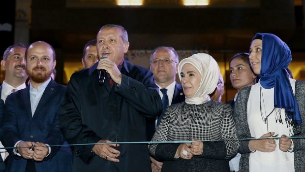 Turkish President Recep Tayyip Erdogan is flanked by his son Bilal and wife Emine in Gaziantep on October 24. Controversial "reforms" of the judiciary saw corruption charges against Bilal Erdogan dropped.