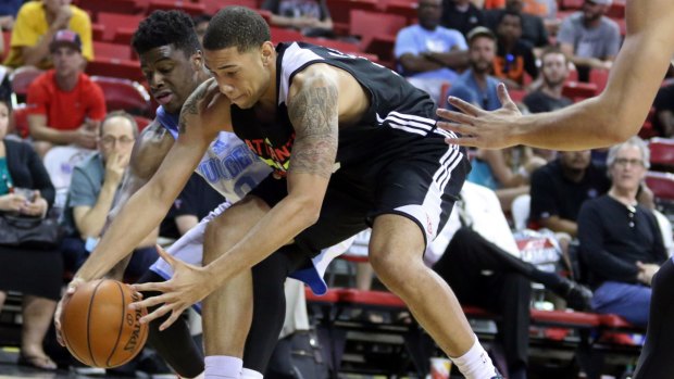Loose ball: Denver guard Emmanuel Mudiay and Atlanta Hawks opponent Brandon Ashley go after possession in their NBA Summer League game in Las Vegas.