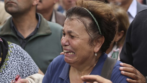 A protester is overcome with emotion at the Sunday rally in Ankara. 