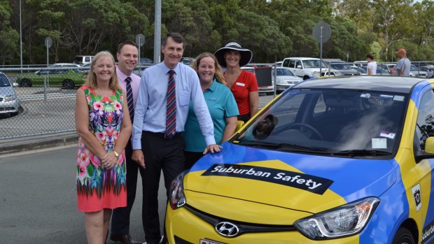 Brisbane City Council's Cr Angela Owen Taylor, Cr Adrian Schrinner, Lord Mayor Graham Quirk, Madonna Stewart from the P&C Association of Queensland LD and Calamvale Community College principal Lisa Starmer with a new parking vehicle which will be used to manage traffic at about 300 Brisbane schools.