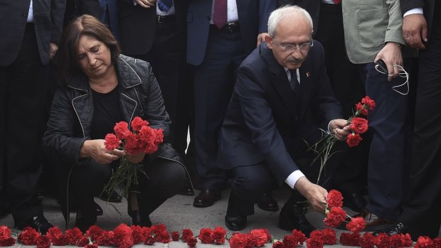Kemal Kilicdaroglu, head of the opposition Republican People's Party, and his wife, Selvi, lay flowers at the site of Saturday's bombings in Ankara.