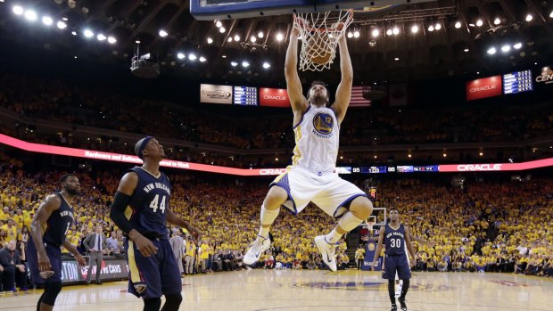 That's two: Golden State Warriors centre Andrew Bogut dunks next to New Orleans Pelicans forward Dante Cunningham during the second half in Game 2 in Oakland. Golden State won 97-87. 