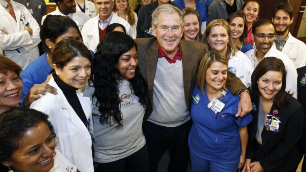 Former US president George W. Bush visits Texas Health Presbyterian Hospital on Friday to celebrate the end of the first major Ebola scare in the United States. To the ex-president's right in the grey T-shirt is Amber Vinson, one of two nurses quarantined after contact with Liberian man Thomas Eric Duncan. Duncan died at the hospital after contracting the disease.