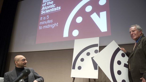 Climate scientist Richard Somerville, a member of the board at Bulletin of the Atomic Scientists, right, unveils the bad news last year, when the clock moved from five minutes to midnight to three.