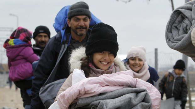 Iraqi refugees in Macedonia walking towards the Serbian border last week.