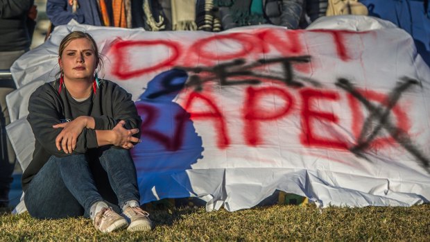 Sexual assault victim Freya protests on the lawns outside Parliament House.