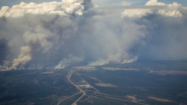 Wildfires burn in and around Fort McMurray, Alberta on Wednesday.