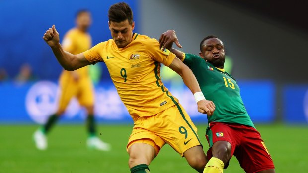Tomi Juric and Sebastien Siani of Cameroon battle for possession during the FIFA Confederations Cup Group B match.