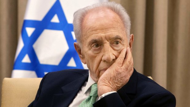 President Shimon Peres listens during a meeting in Jerusalem in 2013.