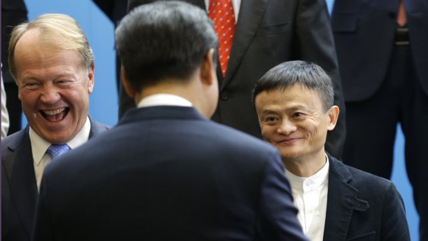 Chinese President Xi Jinping, center, is greeted by Cisco CEO John Chambers, left, and Alibaba executive chairman Jack Ma.