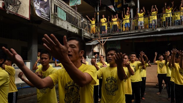 Prisoners sing and dance during an exercise routine at Quezon city jail.