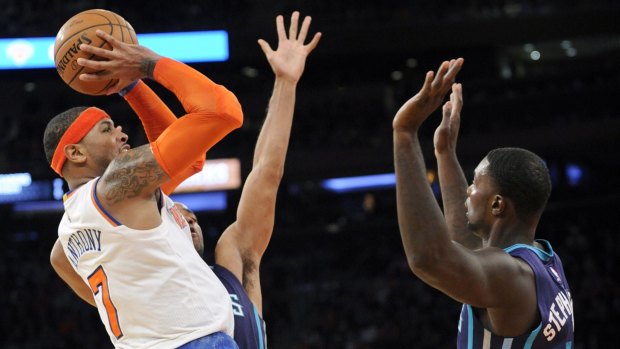 Shooting star: Knicks forward Carmelo Anthony takes a jumper in front of Hornets guard Lance Stephenson.