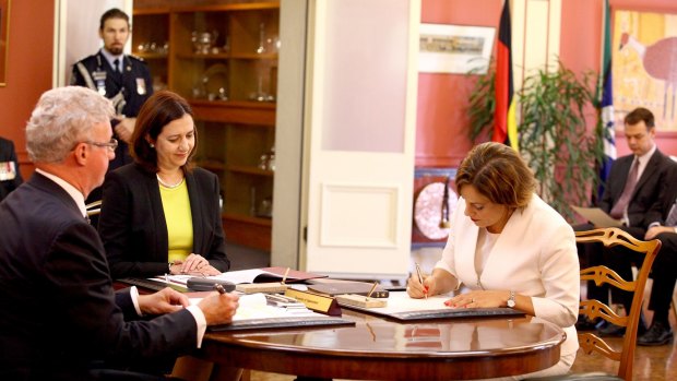 Jackie Trad is sworn in as the Deputy Premier by Governor Paul de Jersey, as Queensland Premier Annastacia Palaszczuk looks on.