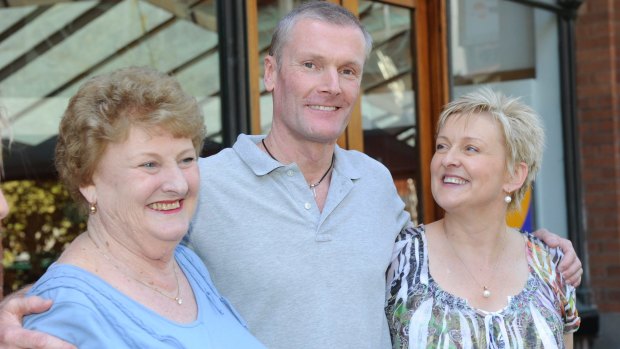 Gordon Wood, pictured with his family after being acquitted of the murder of his girlfriend Caroline Byrne, is suing NSW claiming the pursuit of him cost him millions.