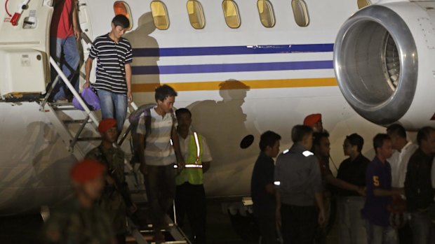 Indonesians crewmen who were taken hostage by Abu Sayyaf in March disembark in Jakarta after being freed last month.