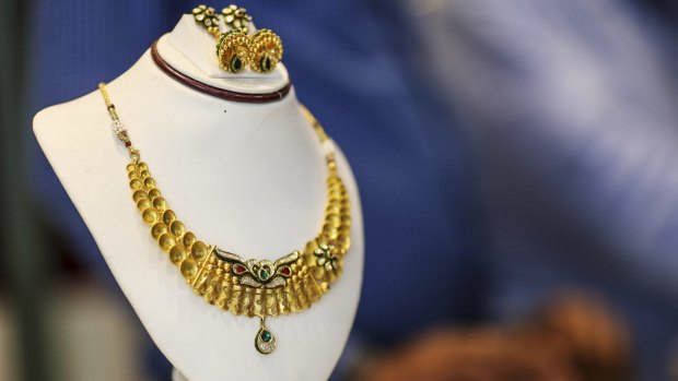 A gold necklace and set of earrings are displayed at the store in Zaveri Bazaar.