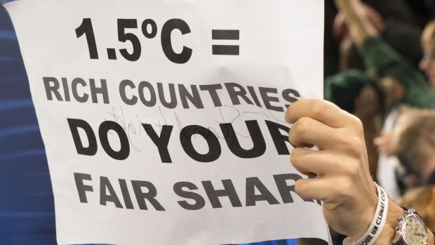 A poster demanding that warming be limited to 1.5 degrees, held up during a protest by activists at the Paris climate talks.
