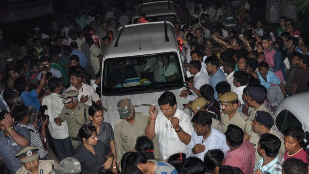 The car carrying Indian Chief Minister of the state of West Bengal Mamata Banerjee (centre) is surrounded by angry demonstrators during a protest following the rape of a nun near the Convent of Jesus and Mary at Ranaghat, north of Kolkata, on Monday. 