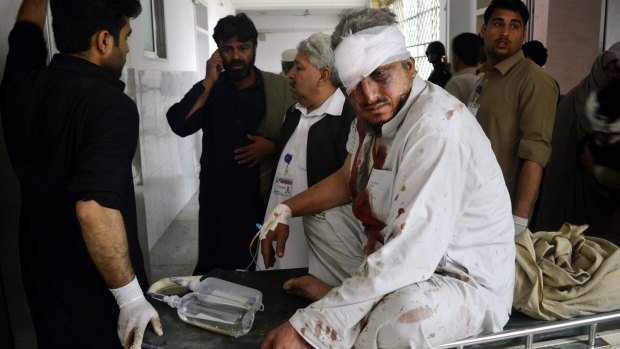 A Pakistani man who was injured in the bomb blast arrives at a hospital in Peshawar.