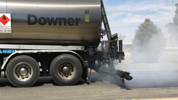 The new road sealer Tonerseal, made from ingredients including recycled tyres and toner, gets sprayed on to the Murray Valley Highway.