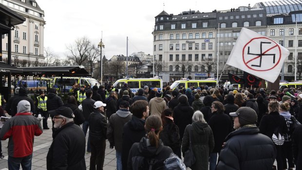 Counter-demonstrators gather to show their disapproval of an anti-migrant demonstration at  Norrmalmstorg Square in Stockholm last week.