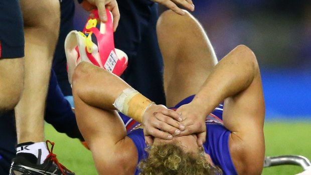 Mitch Wallis lies on the field in agony.