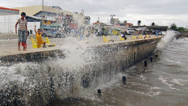 Wild weather: Waves brought by Typhoon Hagupit hit a concrete barrier along the Boulevard Seaport in Surigao City, southern Philippines.