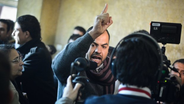 Family members react in a Cairo court following the acquittal of 26 male defendants accused of "debauchery".