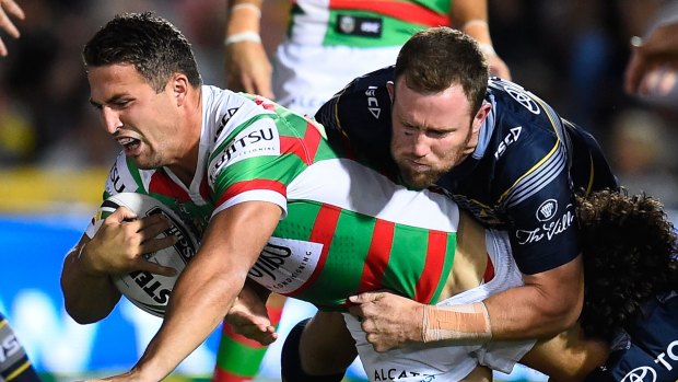 Struggling: Sam Burgess of the Rabbitohs is tackled by Gavin Cooper and Jake Granville.