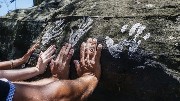 Hand prints are placed at Goat Island by local Aboriginal children.