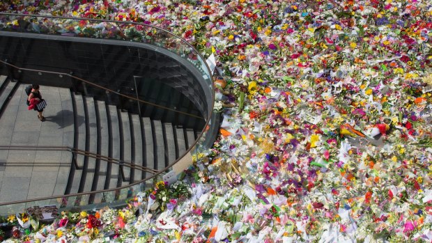 Flowers laid in tribute to the victims of the Sydney siege overwhelmed Martin Place.
