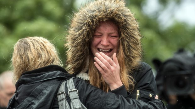 A woman is comforted by her friend on Tuesday as she breaks down in tears after a minute's silence in London near the scene of Saturday's terrorist attack.