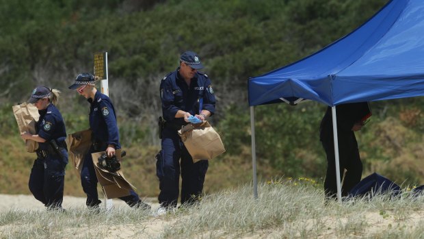 Police at the crime scene on Sunday. 