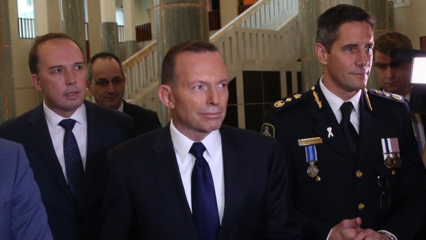 Immigration Minister Peter Dutton and Prime Minister Tony Abbott attend the swearing in ceremony of the inaugural Border Force commissioner Roman Quaedvlieg.