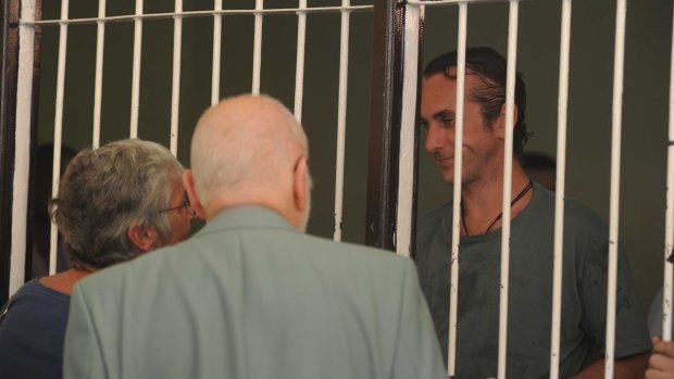 David Taylor speaks with his parents from his holding cell at Denpasar District Court on Tuesday.