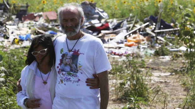 Jerzy and Angela Dyczynski visit the MH17 crash site near the village of Grabovo in Donetsk region on July 26, 2014. 