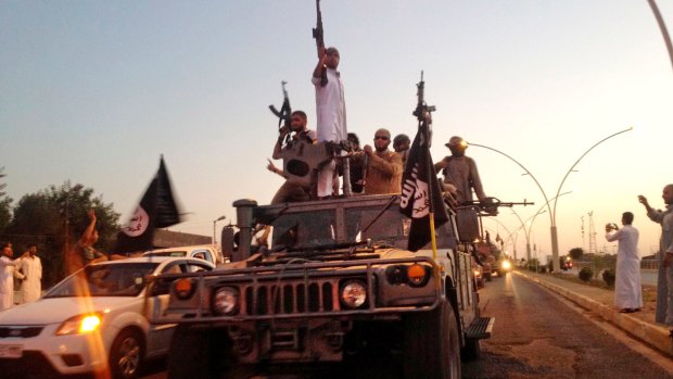 Islamic State fighters roll into Mosul in 2014.