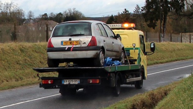 The grey Renault Clio driven by the Kouachi brothers is towed after being found in a forest in north-east of Paris. 