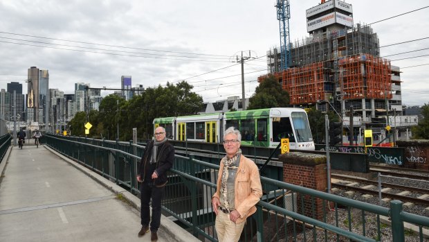 David Brand, left, and Richard Roberts fear the Fishermans Bend development will repeat Southbank's mistakes. The area's first tower, behind them, is now under construction. 