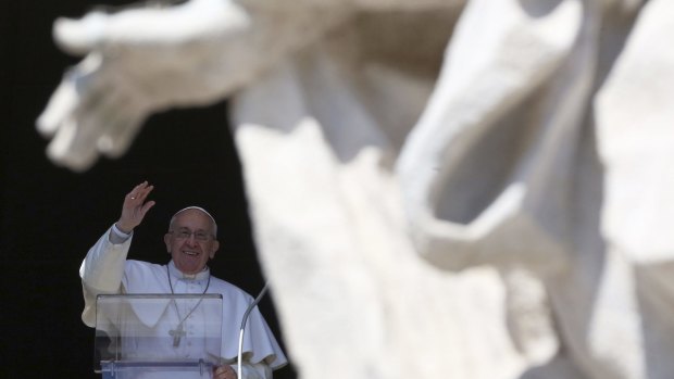 Pope Francis waves during his Sunday Angelus prayer in St Peter's Square yesterday. The Vatican later confirmed it had received a ransom demand for two missing Michelangelo documents.  